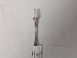 a picture of a silver spoon with a tag attached to it