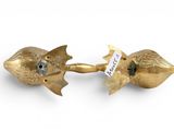 pair of gold fish shaped candlesticks with a label on each of them