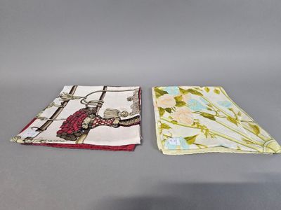 two napkins with birds and flowers on them sitting on a table