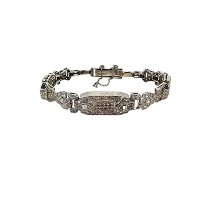 a silver bracelet with diamonds on a white background
