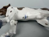 a figurine of a dog laying down on a table