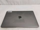 a black apple laptop sitting on a white surface