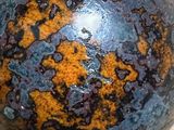 a close up of a metal ball on a wooden surface