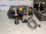 a close up of a drill on a table next to a tool box