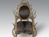 a chair with horns on the back and a leather seat