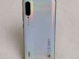 a close up of the back of a phone with a broken screen
