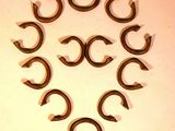 eight horseshoes arranged in a circle on a white surface