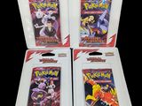trois paquets de cartes à collectionner Pokémon dans leur emballage en plastique