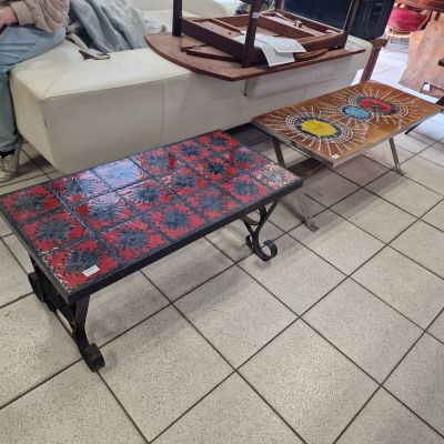 someone is sitting on a couch in a living room with a coffee table