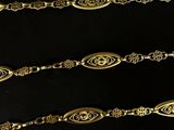 a close up of a group of gold bracelets on a black surface