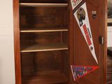 a wooden cabinet with a door open in a room