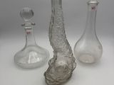 three glass vases sitting next to each other on a table