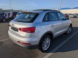 the rear end of a silver volkswagen suv parked in a parking lot