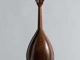 an image of a mandolin sitting on top of a wooden stand