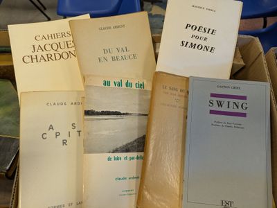 several books are stacked on top of each other on a table