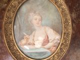 a picture of a woman sitting at a table in a room