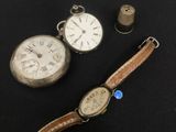 an image of a couple of watches sitting on top of a table