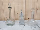 three glass vases sitting on a marble counter top