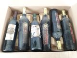 six bouteilles de vin sont posées sur une table dans un carton