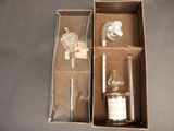 a box with a bottle and a glass inside of it