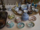 a table that has many different types of oriental items on it