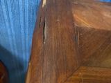 two wooden stools sitting next to each other on the floor