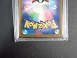 the pokemon card is in a clear plastic case