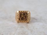an image of a gold ring with a roman numeral on it