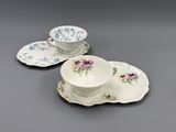 three cups and saucers are sitting on a gray surface
