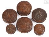 six small wooden boxes with carvings on them sitting on a white surface