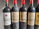 several bottles of wine are lined up in a row on a table