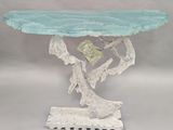 a blue glass table with a tree on top of it