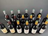many bottles of wine that are lined up on the table