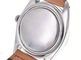 an image of a close up of a watch on a white surface