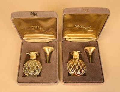 two gold vases in a box on a table