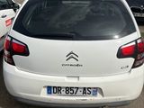 the back of a white citroon parked in a lot next to other cars