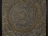 a black and gold painting with a circular design on it