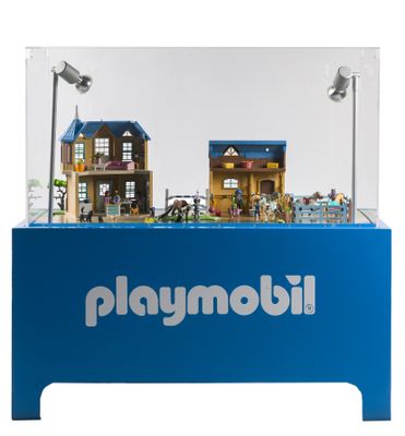 une vitrine Playmobil sur laquelle sont disposées quelques maisons