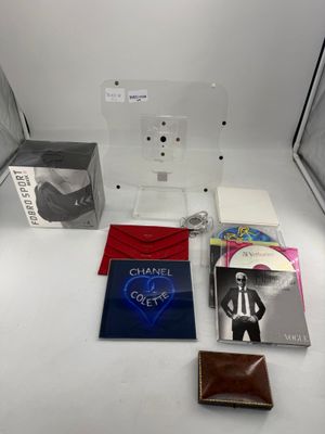 une table sur laquelle se trouvent un ordinateur portable, un portefeuille et d'autres objets