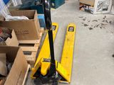 a man standing in a room with a lot of tools on the floor