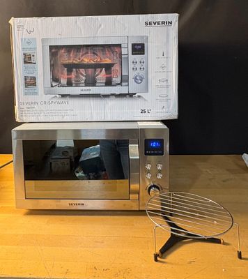 a microwave sitting on top of a wooden table