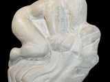 a statue of a woman sitting on a rock