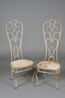 pair of antique wrought chairs with upholstered seat cushions