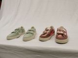 three pairs of sneakers are lined up on a white surface