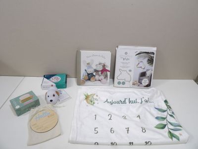 a white table with various items on it that include a calendar, cards, and a teddy bear