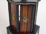 a small wooden box with a clock on top of it
