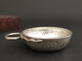 a silver bowl sitting on a table next to a wooden box