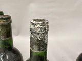 three wine bottles that are sitting on a table