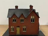 a small model of a house sitting on a table