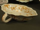 a bowl, plate, and teapot sitting on a table